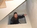 Rabbi Katz inspects one of the rain reservoirs. Rabbi Katz inspects one of the rain reservoirs.